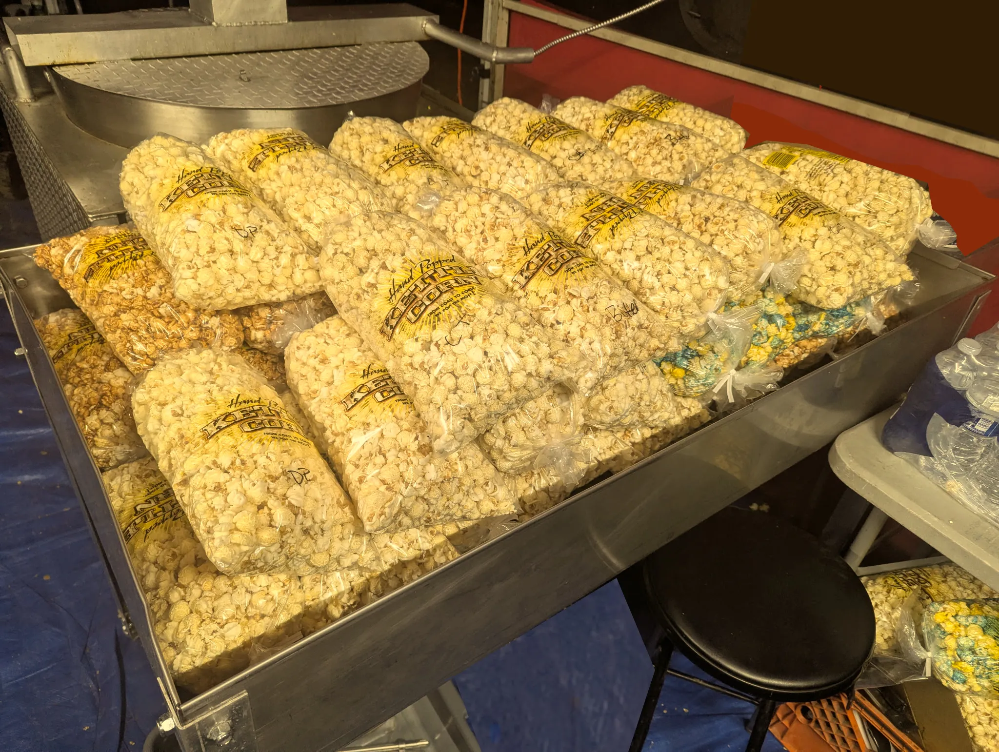 Freshly bagged hand-popped kettle corn stacked in the sifting tray