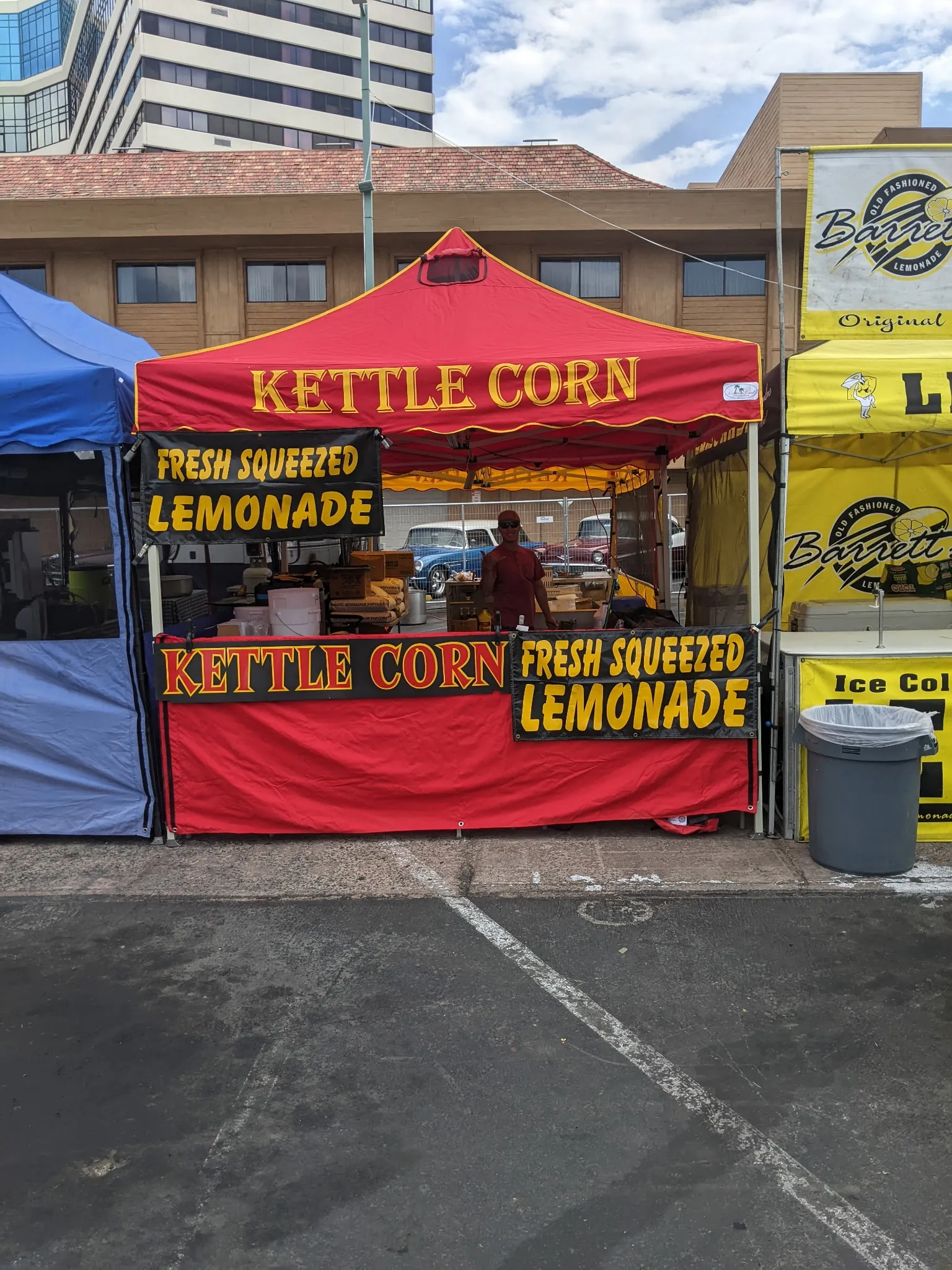 Red tent with kettle corn and fresh squeezed lemonade banners